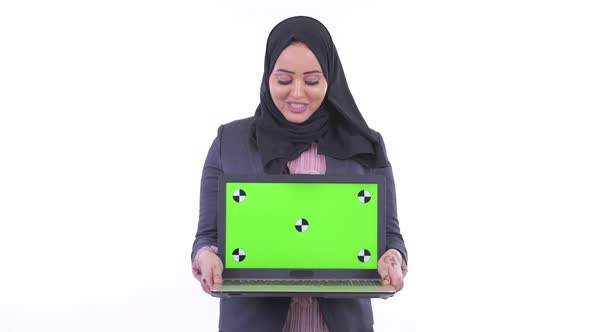 Happy Young African Muslim Businesswoman Talking While Showing Laptop