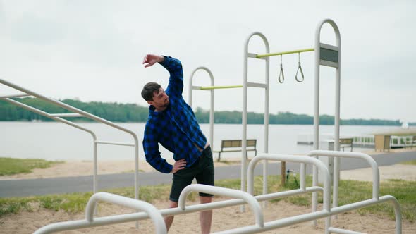 Young Strong Man Exercising on the Beach