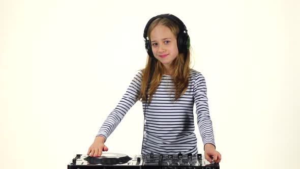 Girl in Headphones Plays for Console. White Background, Slow Motion