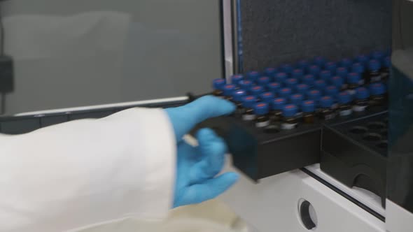 Analytical Chemist Puts a Vials To Auto Sampler of HPLC System. 