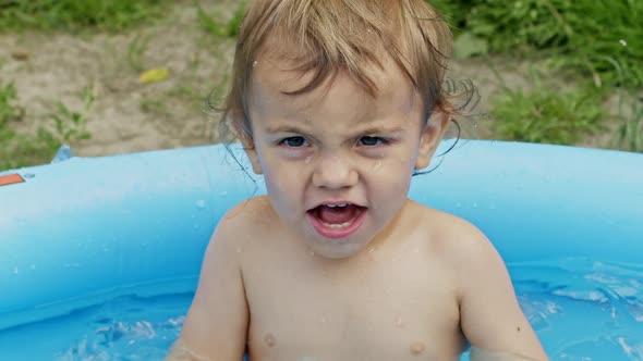 Cute Little Child Bathing in Blue Street Pool in Courtyard. Portrait of Joyful Toddler, Baby. Kid