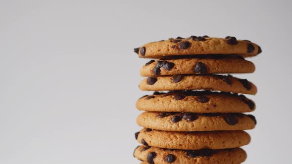 A Stack of Chocolate Chip Cookies Rotate on a Light Background