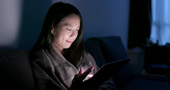 Woman use of tablet and feeling eye pain at home in the evening