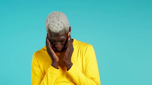 Young African American Man Having Headache, Studio Portrait. Guy Putting Hands on Head, Isolated on