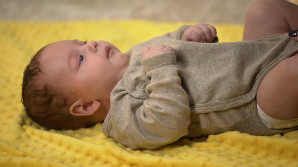 Lady Dressing Up Cute Tiny Kid After Changing Diapers, Child Natural Clothing