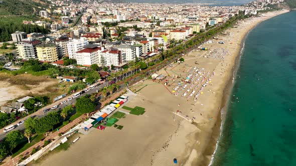 Aerial drone view of parachute jumper flying over beautiful beach