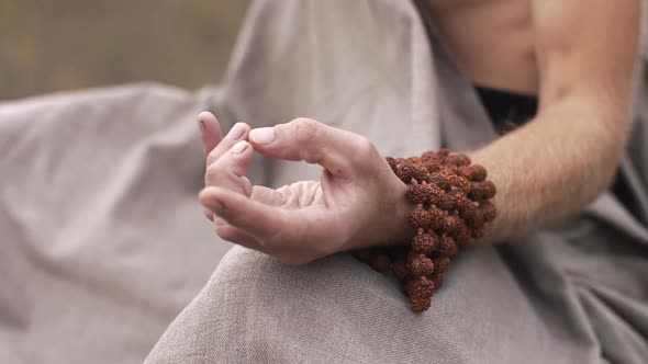 Hand of Meditating Yogi on Nature