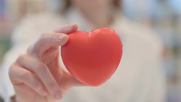 Close Up Woman Holding Heart Shape Object