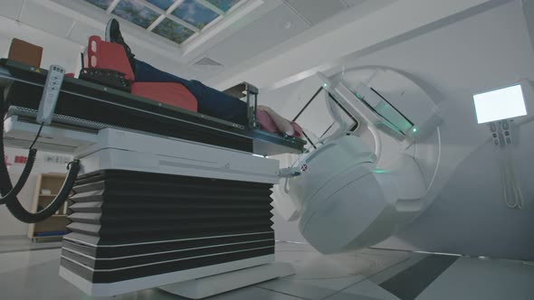 Patient Getting Radiation Therapy Treatment Inside A Modern Radiotherapy Room