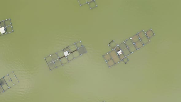 Aerial view of local fishing trap net in canel with fisherman home, lake or river at sunset. Nature