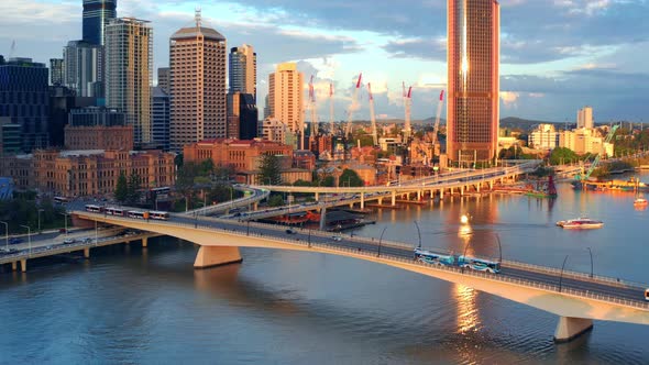 Traffic At The Victoria Bridge At Sunset Over The Brisbane River With View Of 1 William Street Tower