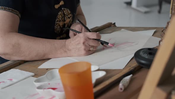 Senior Female Painting in an Art Studio