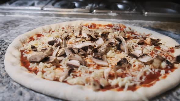 The Chef Hand Deliciously Throws the Sliced Mushrooms on the Pizza. Slow Motion