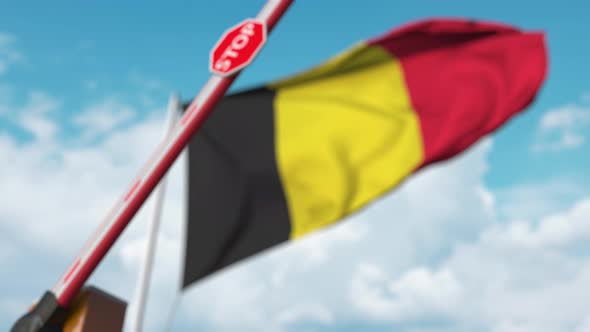 Barrier Gate Being Closed with Flag of Belgium As a Background