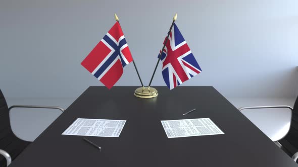 Flags of Norway and the United Kingdom on the Table