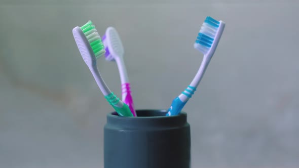 Family concept of three people. A circular panorama around three multi-colored toothbrushes.	