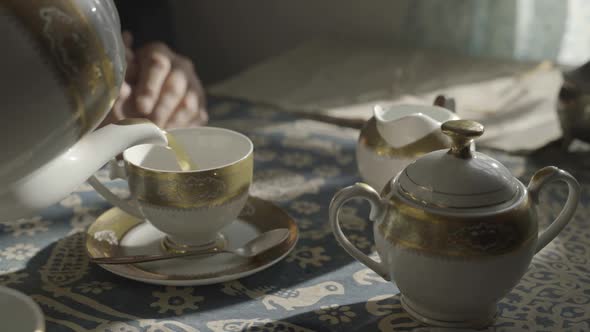 Woman is Poring Tea
