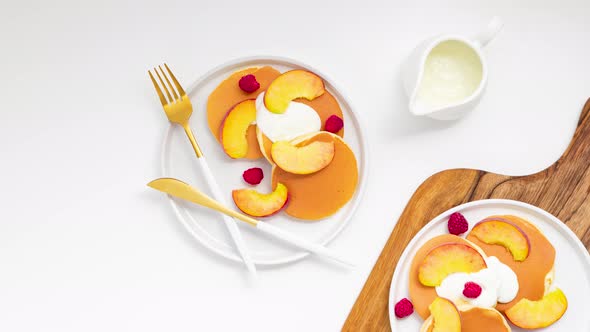 Top view of pancakes with peaches and yogurt. Stop Motion Animation.