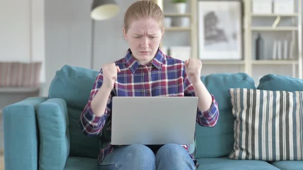 Young Woman Getting Angry While Using Laptop