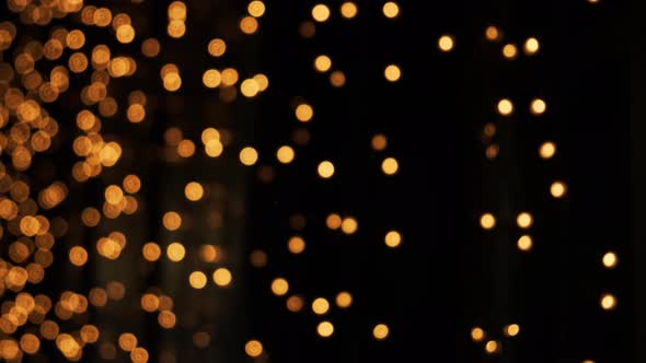 Orange Bokeh Christmas Garlands in Defocus. Blurred Abstract Particles Background