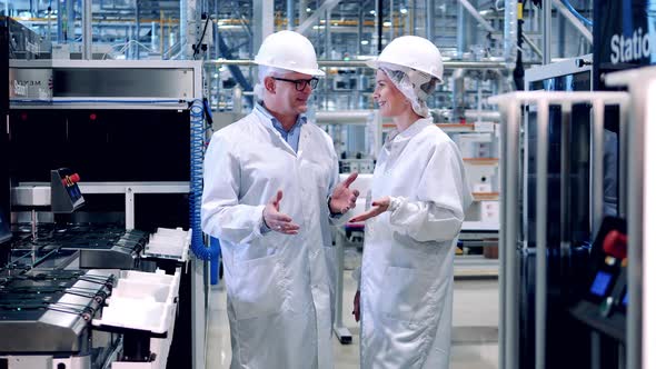 Two Engineers are Smiling While Talking at the Solar Cell Plant