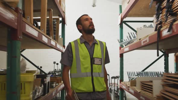 Worker walking between two shelves