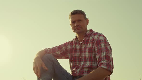 Farmer Resting Sunlight Field at Clear Sky