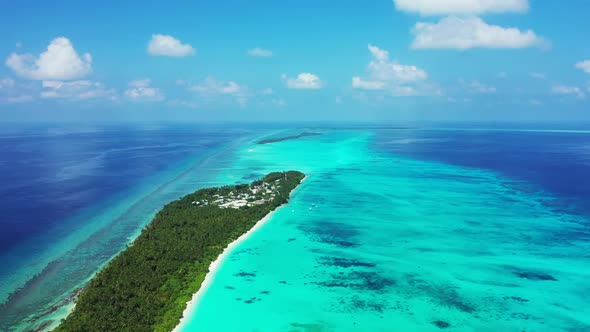 Aerial flying over travel of relaxing shore beach lifestyle by aqua blue ocean with white sand backg