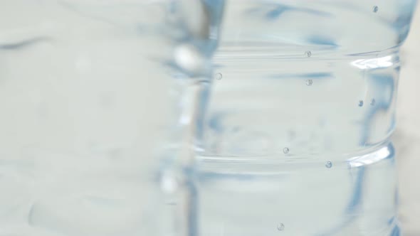 Pure water in PET container close-up 3840X2160 UltraHD footage - Transparent air bubbles  trapped in