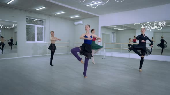 Group of Talented Ballerinas Rehearsing Simultaneous Ballroom Turn