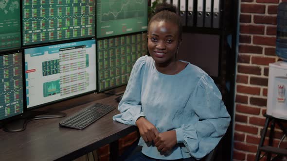 Portrait of Female Broker Using Multi Monitors to Watch Trade Market