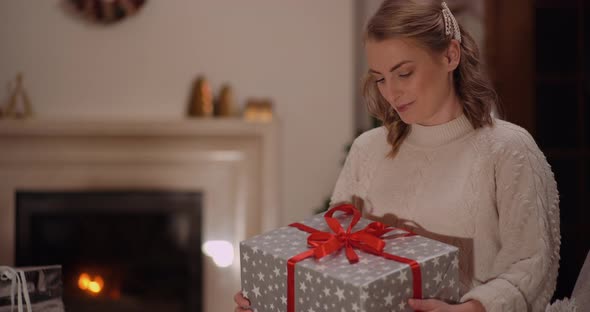 Happy Woman Unboxing Christmas Gift