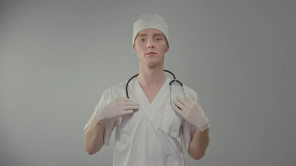 Young Doctor In Medical Gown And Gloves