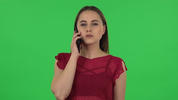 Portrait of Tender Girl in Red Dress Is Talking for Mobile. Green Screen