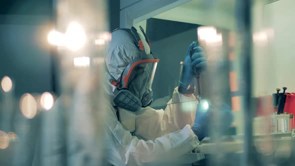 Laboratory Unit and a Scientist Testing Samples in Tubes