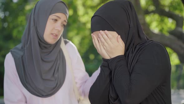 Desperate Muslim Woman in Hijab Crying As Friend Calming Her Down. Portrait of Young University