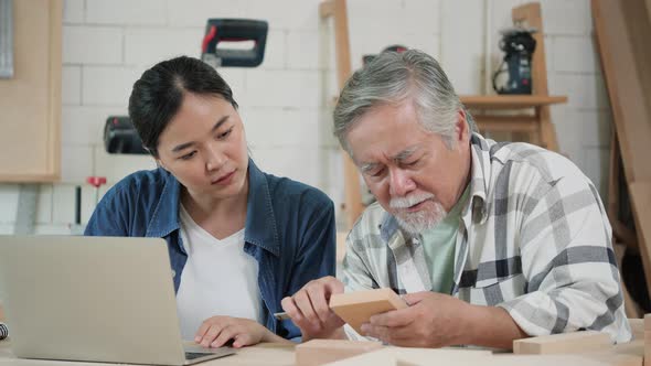 Senior man and woman working with wood