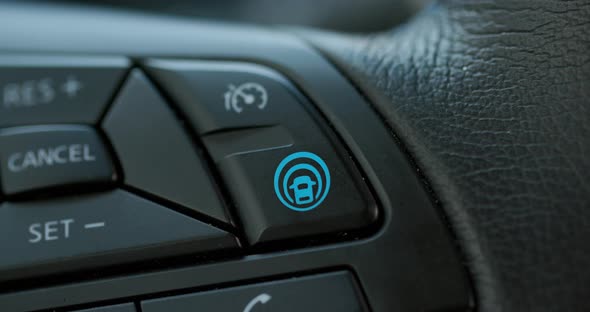 Female Finger Pressing Autopilot Button on Modern Electric Car