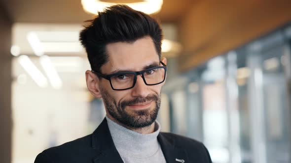 Close-up Portrait of Attractive Bearded Brunet Businessman Smiling in Cafe