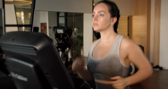 Young Indian Girl Working Out on a Treadmill in a Fitness Room