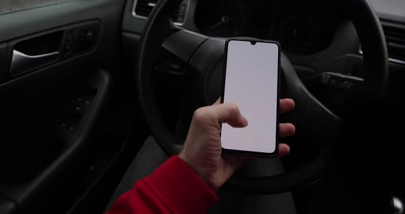 Male Hand Using Empty Screen of Smartphone in a Car