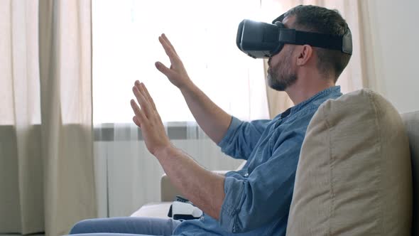 Man in VR Goggles Gesturing