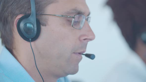 Focused Male Call Center Worker Headset Taking Call