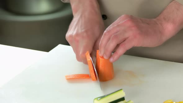 Hands Cutting Carrot.