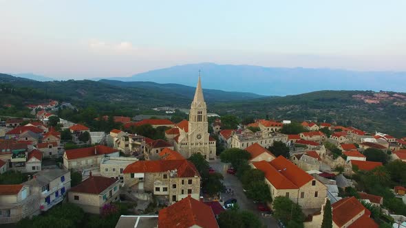 Moving aerial drone point of view of St. Nicholas Church in Selca Croatia Europe