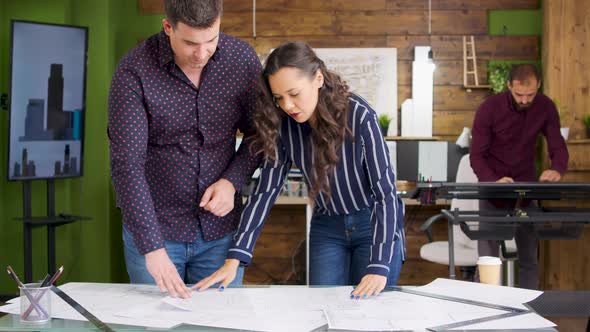 Female Architect Talking with Her Builder for a New House Project