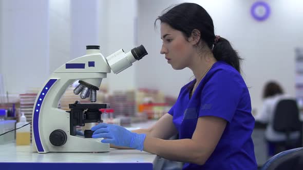 Young Pretty Woman Doing Analysis in the Laboratory Close Up. Conducting Research in Laboratory