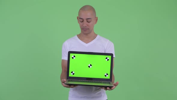 Stressed Bald Man Showing Laptop and Getting Bad News