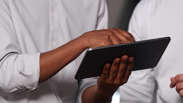 Expressive colleagues with a tablet talking about business