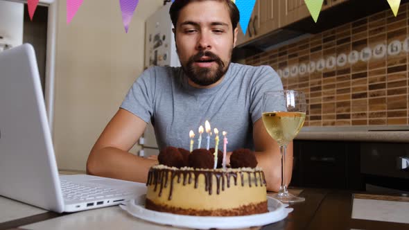 Man Blowing Out the Candle on the Birthday Cake and Making Video Call